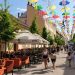 Vibrant umbrellas decorate a lively street in Bjelovar, Croatia, creating a festive atmosphere.